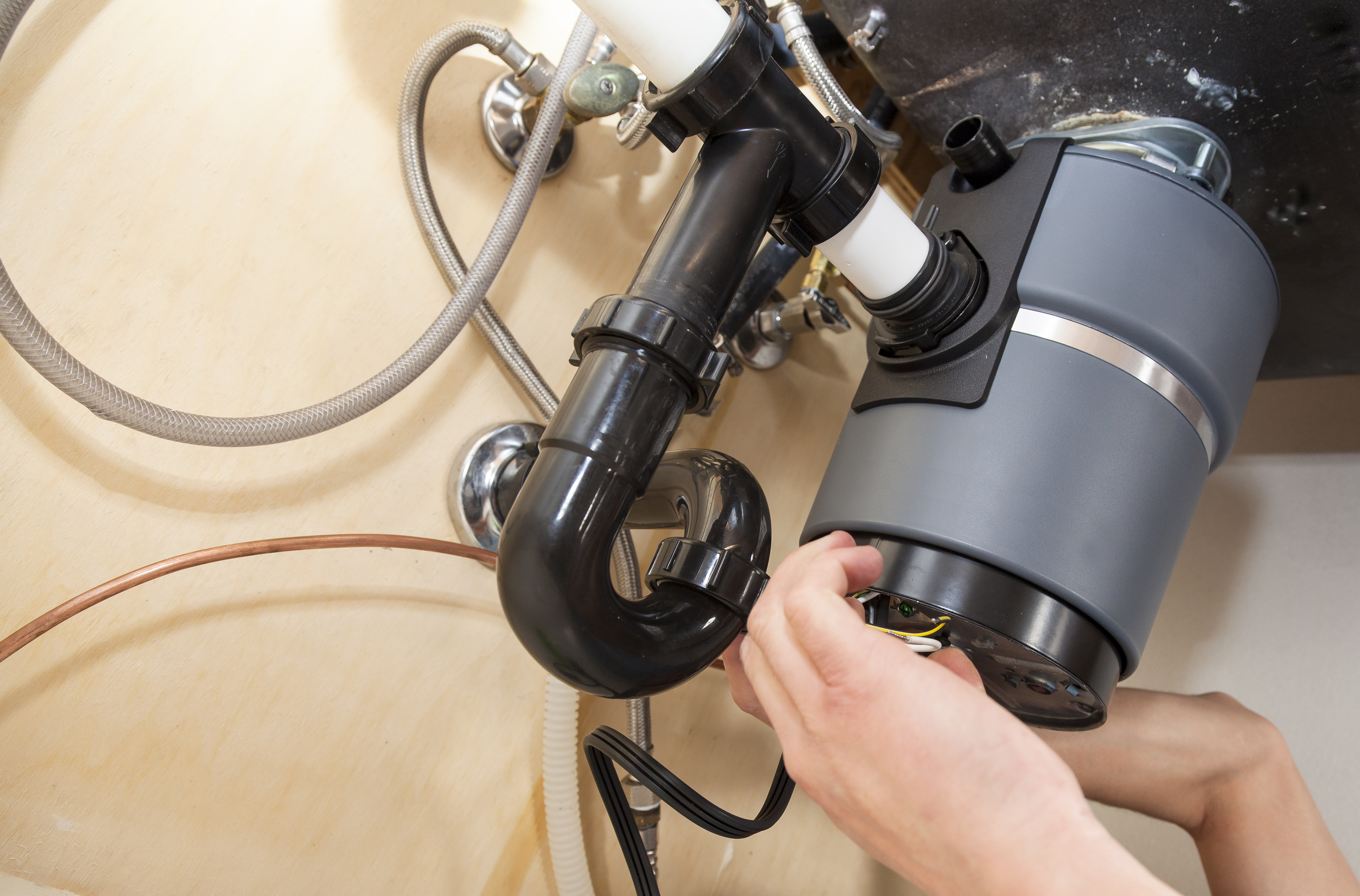 How to find the red button and reset the garbage disposal