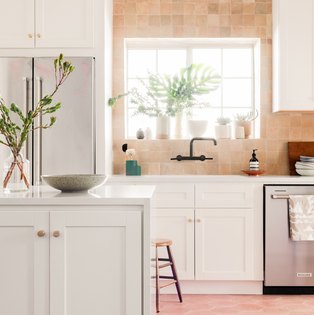 A light pink tile backsplash kitchen view