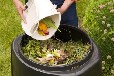 Adding to a compost bin.