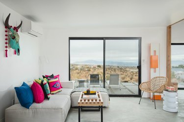 A slider door reveals view of desert from living room area.