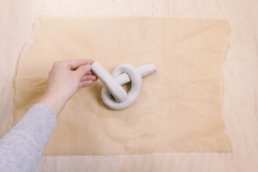 Folding tail of air dry clay up to form a knot