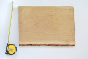 Piece of natural wood and a tape measure