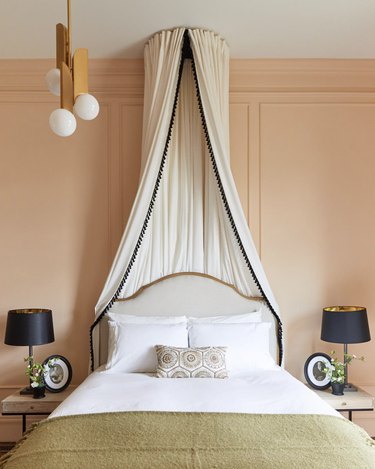 Victorian bedroom with white canopy mounted to ceiling