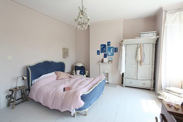 Victorian bedroom with upholstered bed and antiques