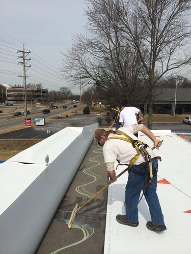 Installing TPO roofing.