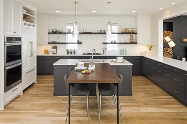 T-shaped kitchen island created with blue kitchen island and wood kitchen table