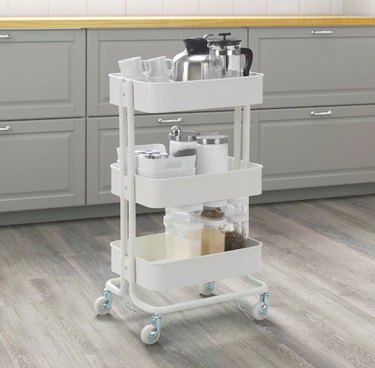white utility cart with kitchenware
