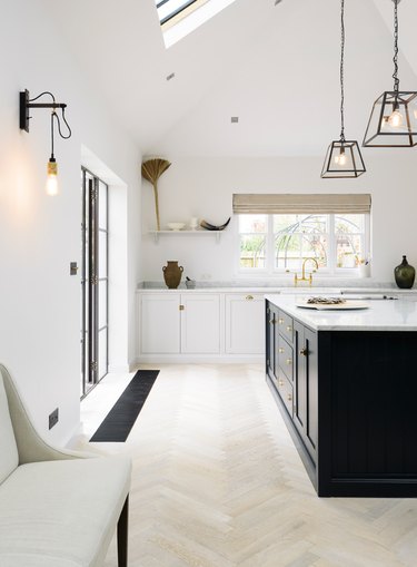 Light wood herringbone kitchen floor in modern, minimalist kitchen