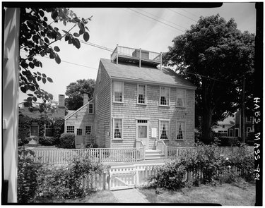 The Swain-Mitchell House in Nantucket featuring a rooftop scuttle and chimney