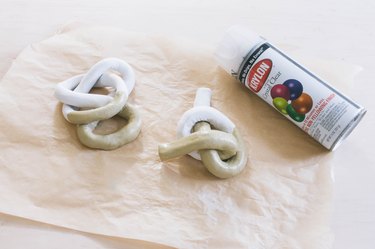 clear gloss acrylic spray applied to two clay knot sculptures