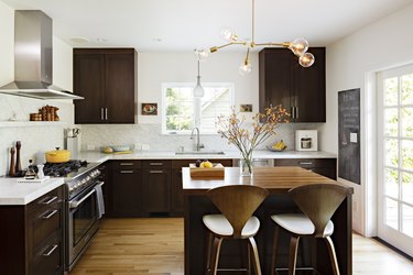 espresso kitchen island in midcentury space with dark cabinets