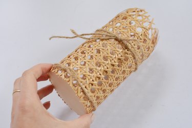 Cane cylinder with jute string wrapped around.