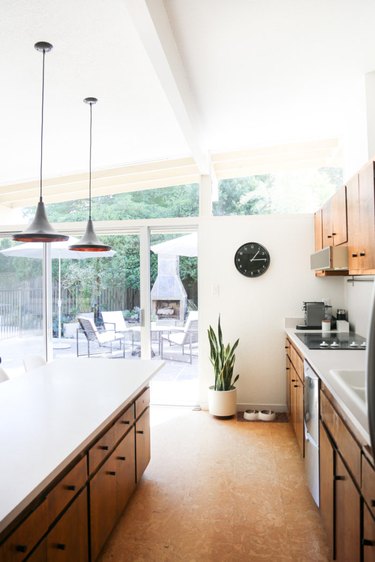 kitchen space with hanging lighting fixtures and cork flooring