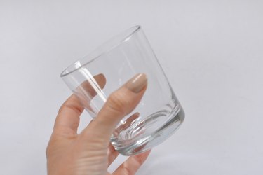 Hand holding glass.
