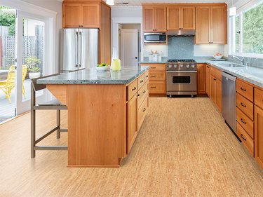 kitchen space with wood cabinets and cork flooring