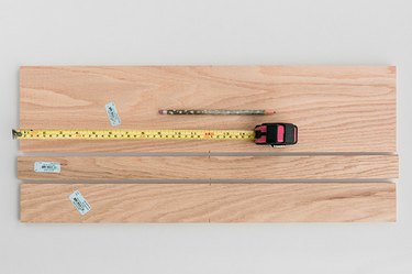 Measure and mark the wood boards down the center of each.