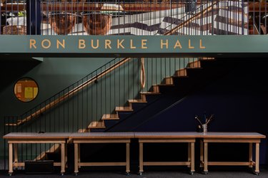 Graphic staircase with teal walls and plywood stairs