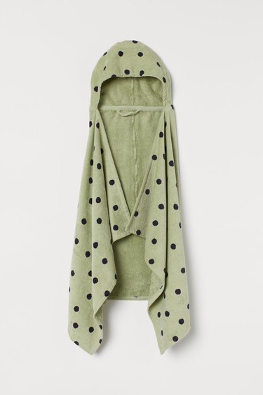 green hooded bath towel with black polka dots