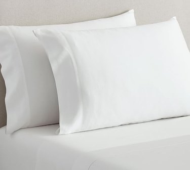 cream colored pillows and sheet