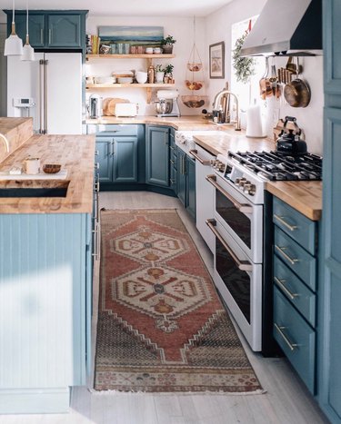 cozy blue kitchen with butcher block countertops