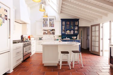 clay tile floor in kitchen, white cabinetry