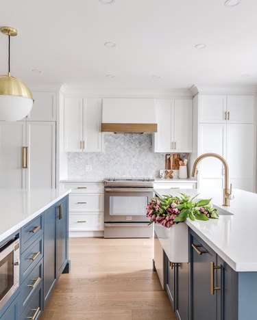 bright white kitchen with blue islands