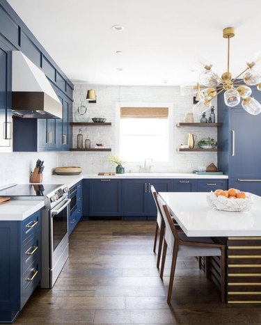 blue shaker-style cabinets with modern gold accents