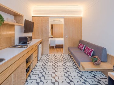 black and white patterned Mexican tile floor in kitchen with wood cabinets