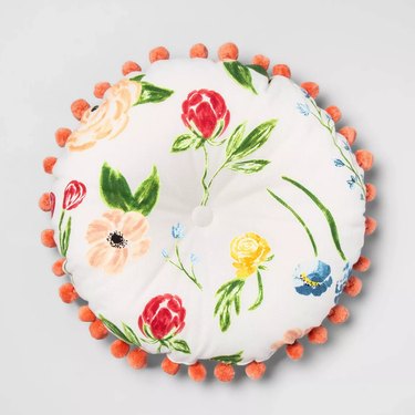 round floral pillow with poms