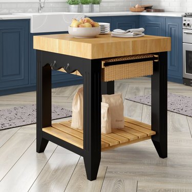 Square kitchen island with butcher block top and storage below
