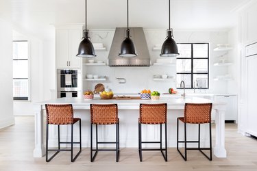 light wood kitchen floors in white space with black accents by Chango & Co.