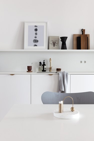 white kitchen with brass cabinet pulls