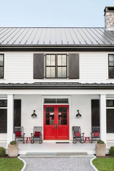 exterior of farmhouse style home with four chairs and red door