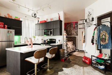 kitchen with red accents, white countertop, dark wood cabinetry