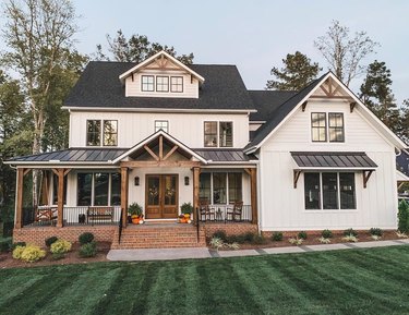 farmhouse exterior with black and white paint and brick steps