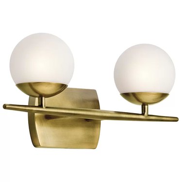 Brass sconce with two white globes joined by brass bar