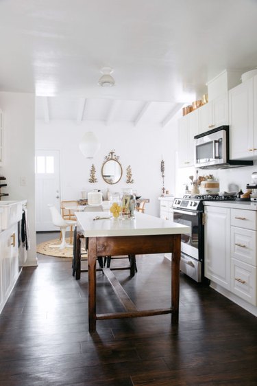 Dark wood kitchen flooring idea with wood table and vintage decor