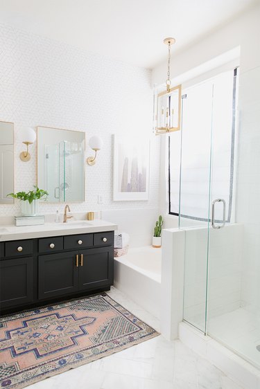 Painted bathroom cabinets before and after featuring white, modern bath and black cabinets