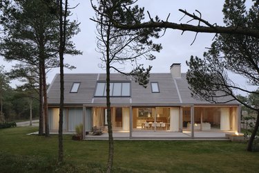 Scandinavian style house seem from the outside with trees nearby