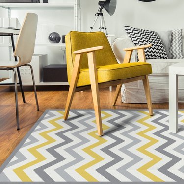 living room space with yellow and gray chevron pattern rug and yellow chair