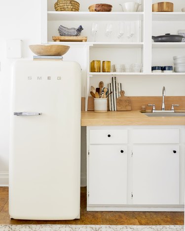 Desert-Themed Kitchen with white cabinets and wood countertop