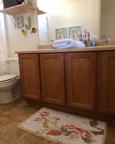Painted bathroom cabinets before and after featuring dark wood cabinets