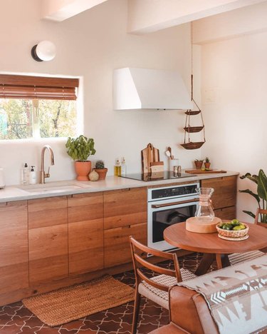 Desert-Themed Kitchen with wood cabinets and tile floor by Joshua Tree House