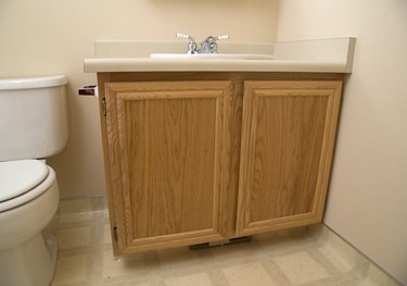 Painted bathroom cabinets before and after featuring oak cabinets