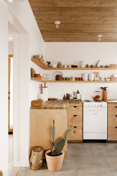 Desert-Themed Kitchen with wood cabinets and open shelving