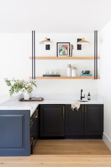 The bar area with dark cabinets and a custom shelf