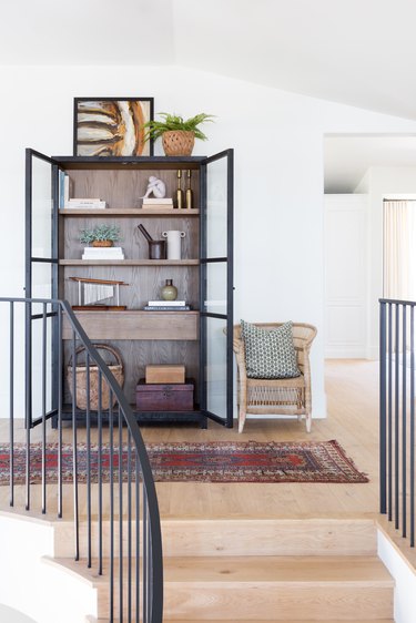 A curated shelf at the top of the stairs