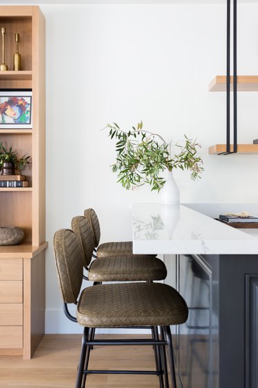 A marble counter and stools in the bar area