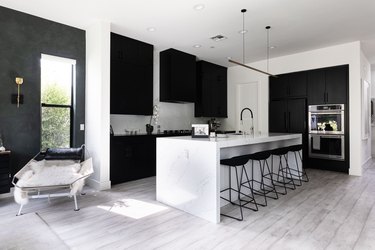 Black and white kitchen, black counter stools, marble kitchen island
