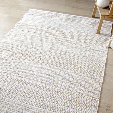 White and cream Scandinavian rug with subtle pattern on floor